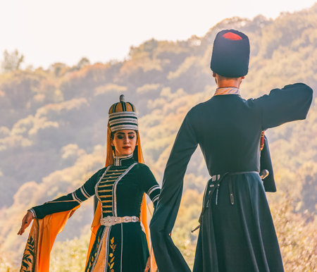 Dakhovskaya, Russia - September 22,  2018: a guy with a girl in traditional Circassian clothes dancing at the festival of Adyghe cheese in the foothills of the Caucasusのeditorial素材