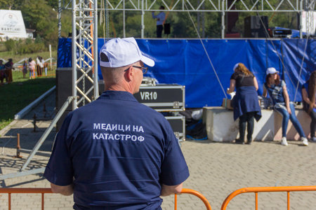 Dakhovskaya, Russia - September 22,  2018: Rescue Officer with the inscription Medicine Accident on the back, stands next to the concert platformのeditorial素材