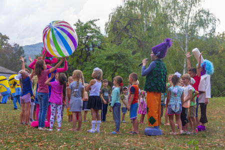 Kamennomostsky, Russia - September 1, 2018: Holiday day of the village with animators and childrens playgrounds and competitions in the park in the autumnのeditorial素材
