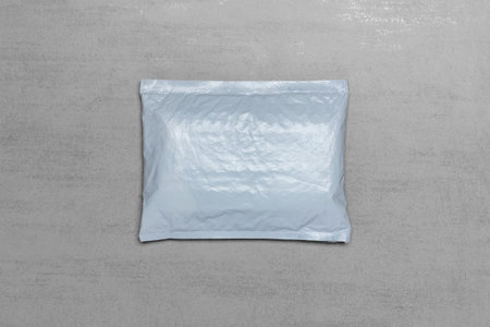 mock up grey postal package from Chinese online store with copy space on grey background, top view...
