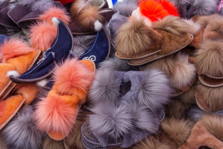 a large pile of warm soft fluffy colorful fur Slippersの写真素材