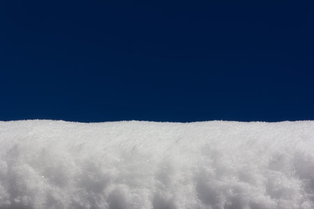 snowdrift on blue sky background close-up, with copy space