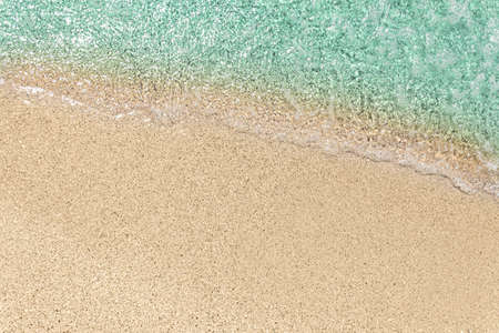 blue sea wave on sandy beach background top view with copy spaceの写真素材