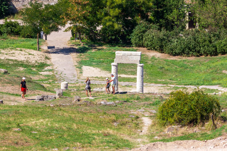 Kerch, Russia - 13 August 2019: Tourists walk through the archaeological dig at the ruins of the ancient Greek city of Pantikapei on mount Mithridates in Kerch on a summer dayのeditorial素材