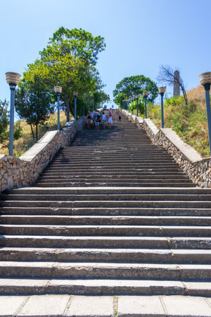 Kerch, Russia - 13 August 2019: tourists go up and down the stone stairs from mount Mithridates on a summer dayのeditorial素材