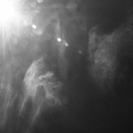 bright summer sun on a blue sky, black and white photoの写真素材