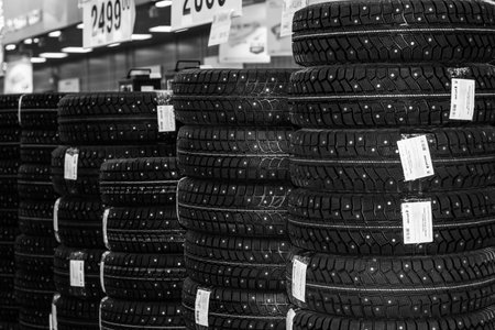 Maikop, Russia - October 16, 2020: racks with new car tires in the store, black and white photoのeditorial素材