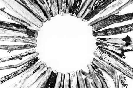 background with a round frame of sea driftwood on a white background top view, black and white photoの写真素材