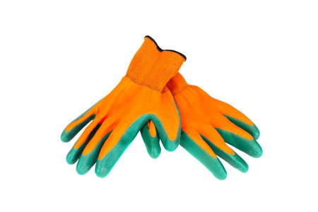 a pair of orange green protective gloves for gardening, construction and repair work isolated on a...