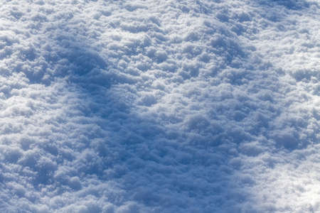 texture of winter snow background with shadow close-upの写真素材
