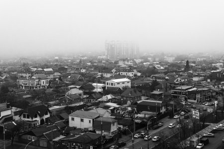 Krasnodar, Russia - December 20, 2020: view of the private sector in Krasnodar on an autumn foggy morning black and white photoのeditorial素材