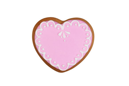 homemade ginger cookies in the shape of a heart with pink glaze isolated on a white background top view with clipping pathの写真素材