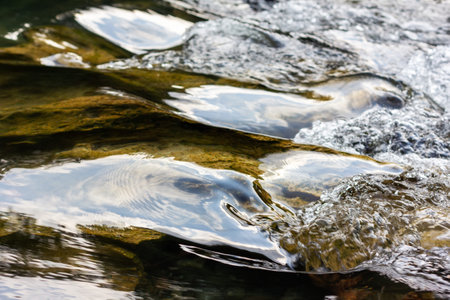 bubbling stream of clear water close-up, selective focusの写真素材