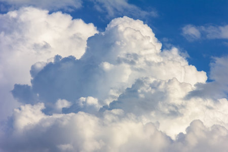 large cumulus clouds in a blue sky close-upの写真素材
