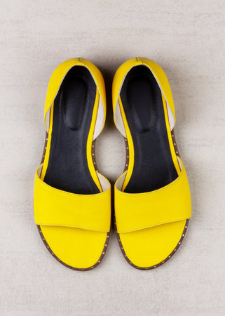 yellow womens summer sandals on a gray background top viewの写真素材