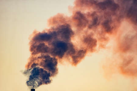 Smoke from a pipe against the sky.の写真素材