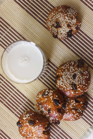 Biscuits on the table with sesame seeds, raisins and a glass of milk. Setの写真素材