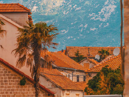 Montenegro, Herceg Novi. Tiled roofs of old town at background of the Adriatic Sea, mountains, cruise liner.の写真素材