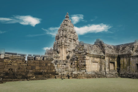 A photograph of ancient temple ruins with intricate stone carvings, set against a clear blue sky....