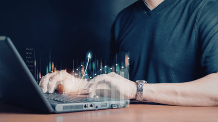 A person is intently analyzing data on a laptop screen, with a holographic interface displaying...