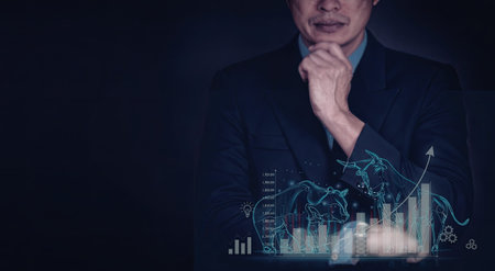 A businessman in a suit is contemplating market trends and data analytics, with a holographic...