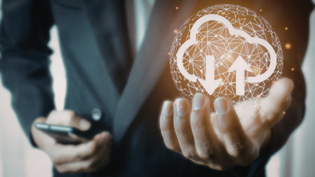 A businessman in a suit is holding a glowing cloud computing symbol with upward arrows, representing...