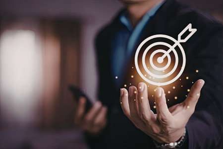 A businessman in a suit is holding a digital target symbol in his hands, symbolizing focus and success in a professional setting.の写真素材