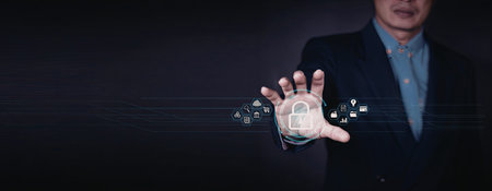 A close-up image of a businessman in a suit interacting with a virtual globe using his hand. The...