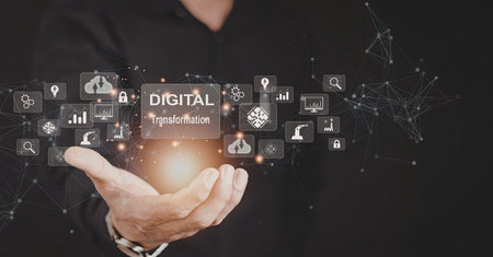 A person holding a glowing digital transformation icon surrounded by various technology and data...