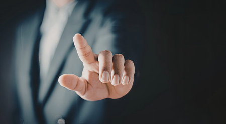 A close-up image of a hand making a specific gesture, likely indicating a point or emphasis, in a...
