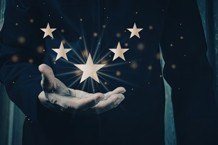 An image of a hand holding a cluster of radiant stars, with a dark blue background adorned with...