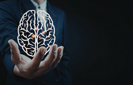 A person in a suit holding a glowing brain model, emphasizing technology and intelligence.