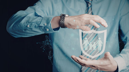 A person holding a digital shield that displays a family icon, emphasizing protection and security.の写真素材