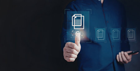 A person in a blue shirt is interacting with a digital interface, selecting a document icon from multiple options displayed on a screen.の写真素材