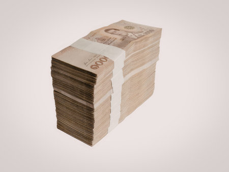 A neatly stacked bundle of Canadian dollar bills, secured with a paper band.