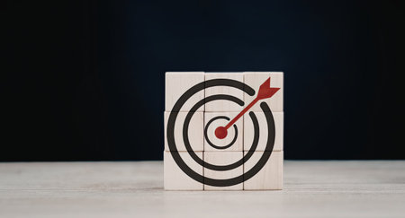 A red arrow successfully hits the bullseye of a target on a white block, symbolizing achievement and...
