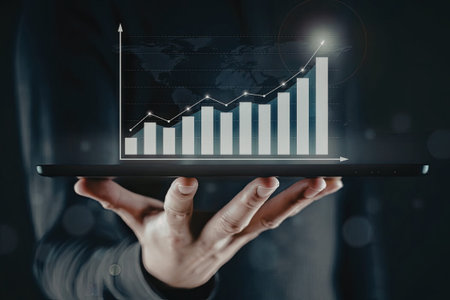 A person holding a tablet displaying a bar graph with an upward trend, indicating growth or positive results.の写真素材
