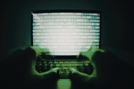 A laptop screen displaying binary code with a green backlight, highlighting the digital and...