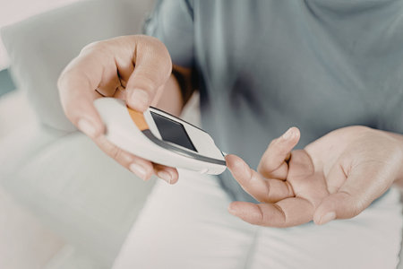 A close-up image of a person holding and using a smartphone. The individual is focused on the...