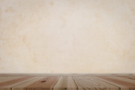 A simple wooden table with a light brown finish is set against a vintage, textured wall background....