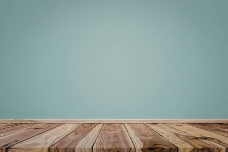 A close-up view of a wooden table top set against a clear blue sky background. The table top...