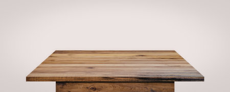A close-up view of a wooden table top showcasing its natural grain and texture. The table appears to be made from a single piece of wood, highlighting the beauty of its natural patterns and colors.の写真素材