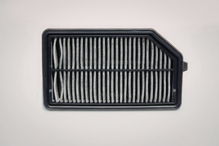 An image of a black air filter with a rectangular design featuring horizontal slats. The filter is...