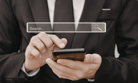 A close-up image of a businessman in a suit using a smartphone with a search bar overlay.