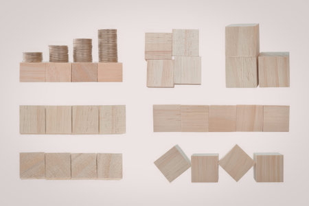 An assortment of wooden cubes and blocks of varying sizes and shapes arranged neatly in rows and...