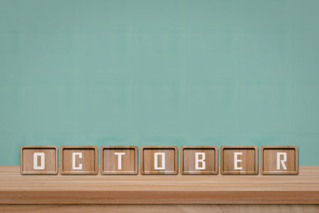 An image of wooden blocks arranged to spell out the word 'OCTOBER' against a light blue background.