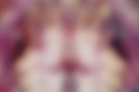 A highly blurred image showcasing a mix of pink, purple, and yellow colors, creating an abstract visual effect.の写真素材