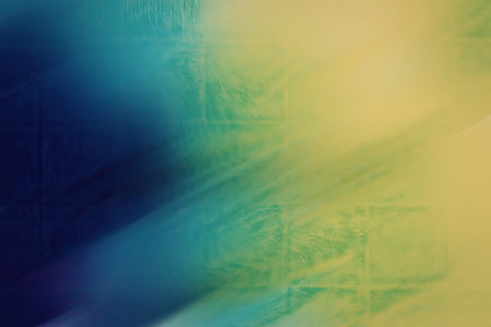 A dynamic diagonal gradient background featuring a blend of blue, green, and yellow hues, creating a visually appealing and modern abstract design.の写真素材