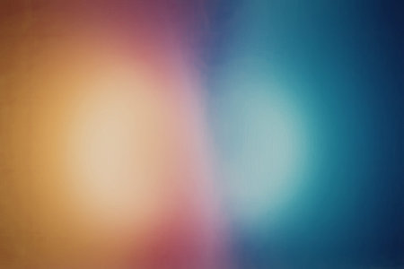 A colorful gradient background featuring a blend of orange, pink, purple, and blue hues with a bright light effect.の写真素材