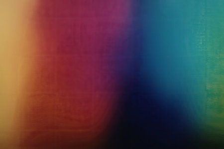 A visually appealing image featuring a rainbow gradient that transitions smoothly from yellow to red, purple, blue, and green, with a soft blur effect around the edges, creating a mesmerizing and colorful background.の写真素材